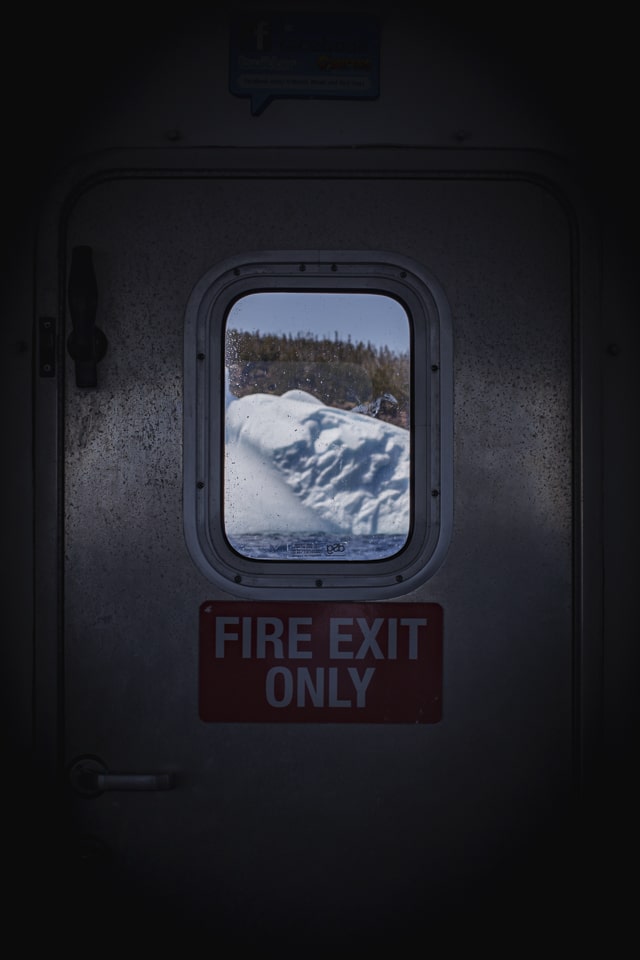 Through our boat's windows, peaceful giant of ice slide on our sides