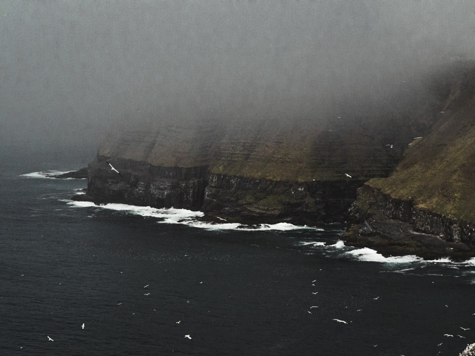The cliffs are relentlessly attacked by the seafoam and the fog